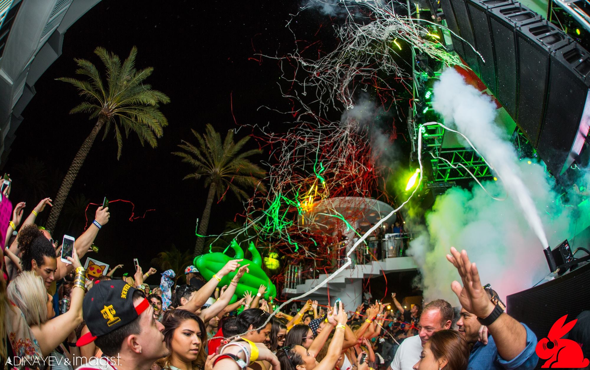 Elevated night view of the pool stage and a packed Miami Beach crowd