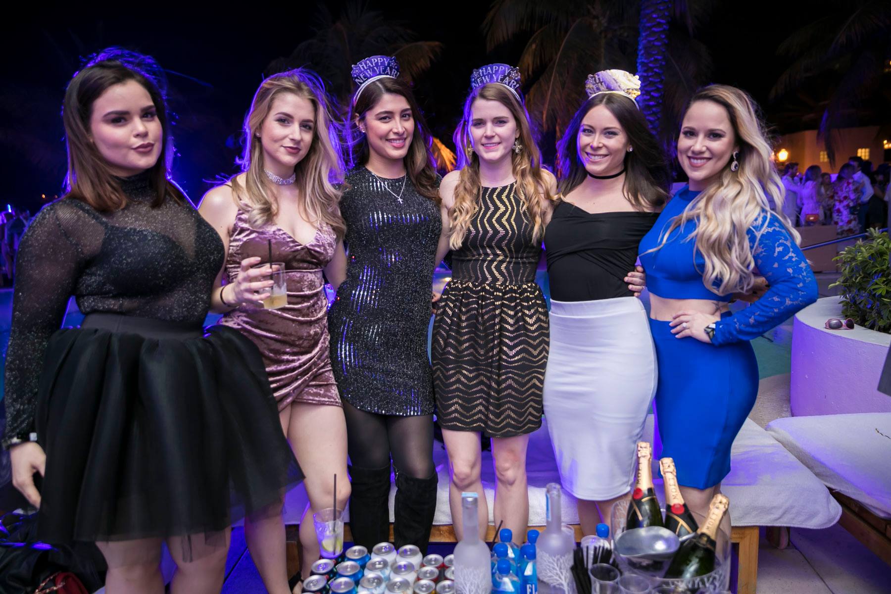 Six guests at a bottle-service banquette with champagne on the table