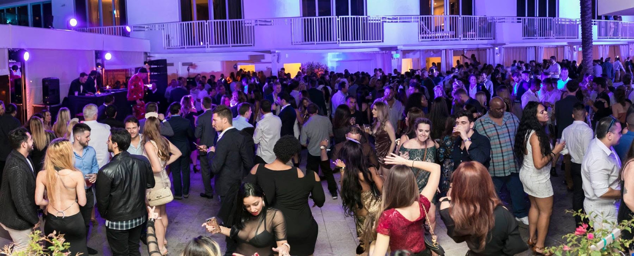 The courtyard dancefloor at full capacity under purple light