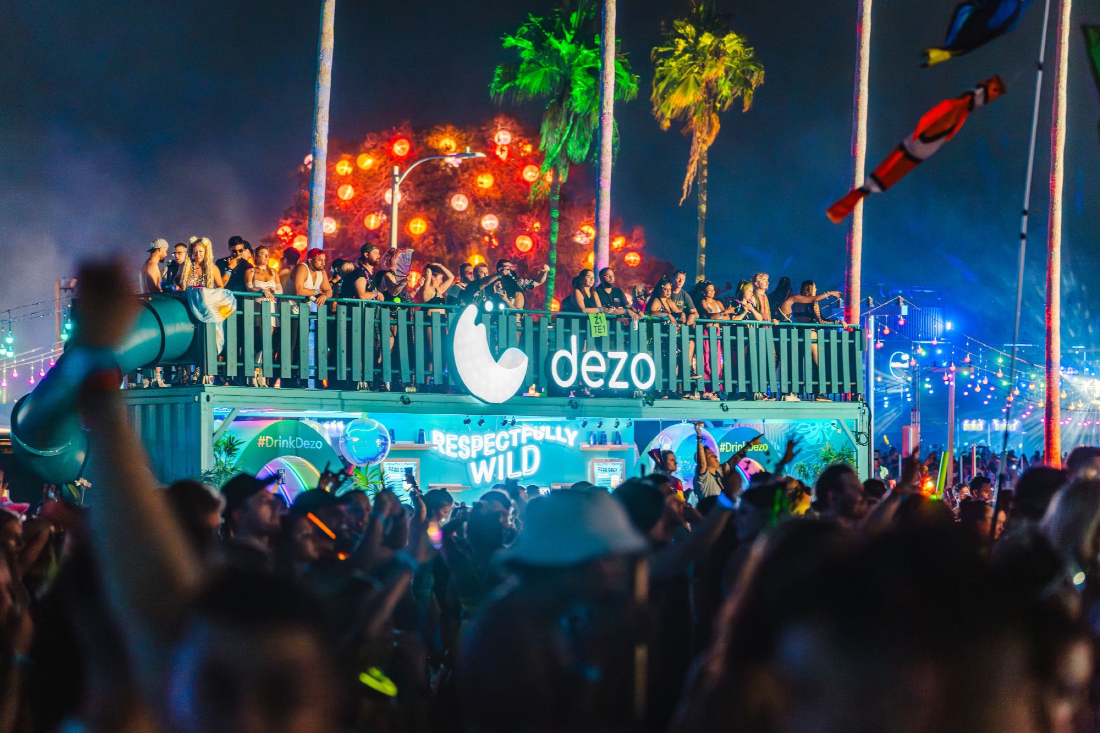 Dezo double-decker activation glowing over the night crowd