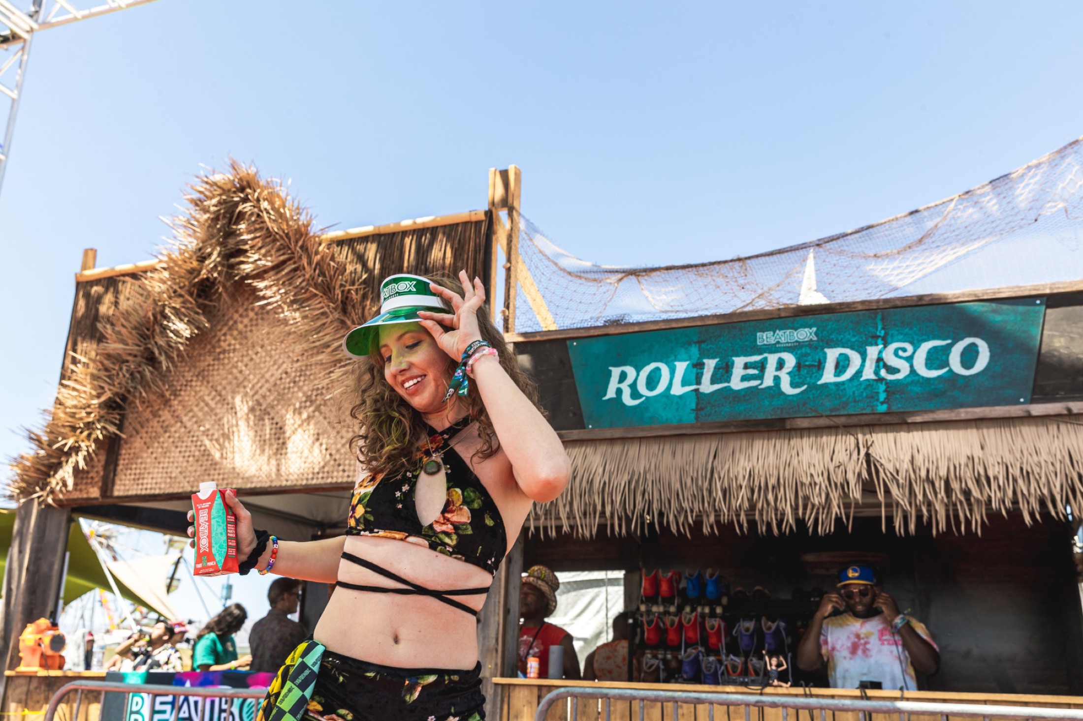 BeatBox Roller Disco activation — fan in a BeatBox visor at the tiki booth