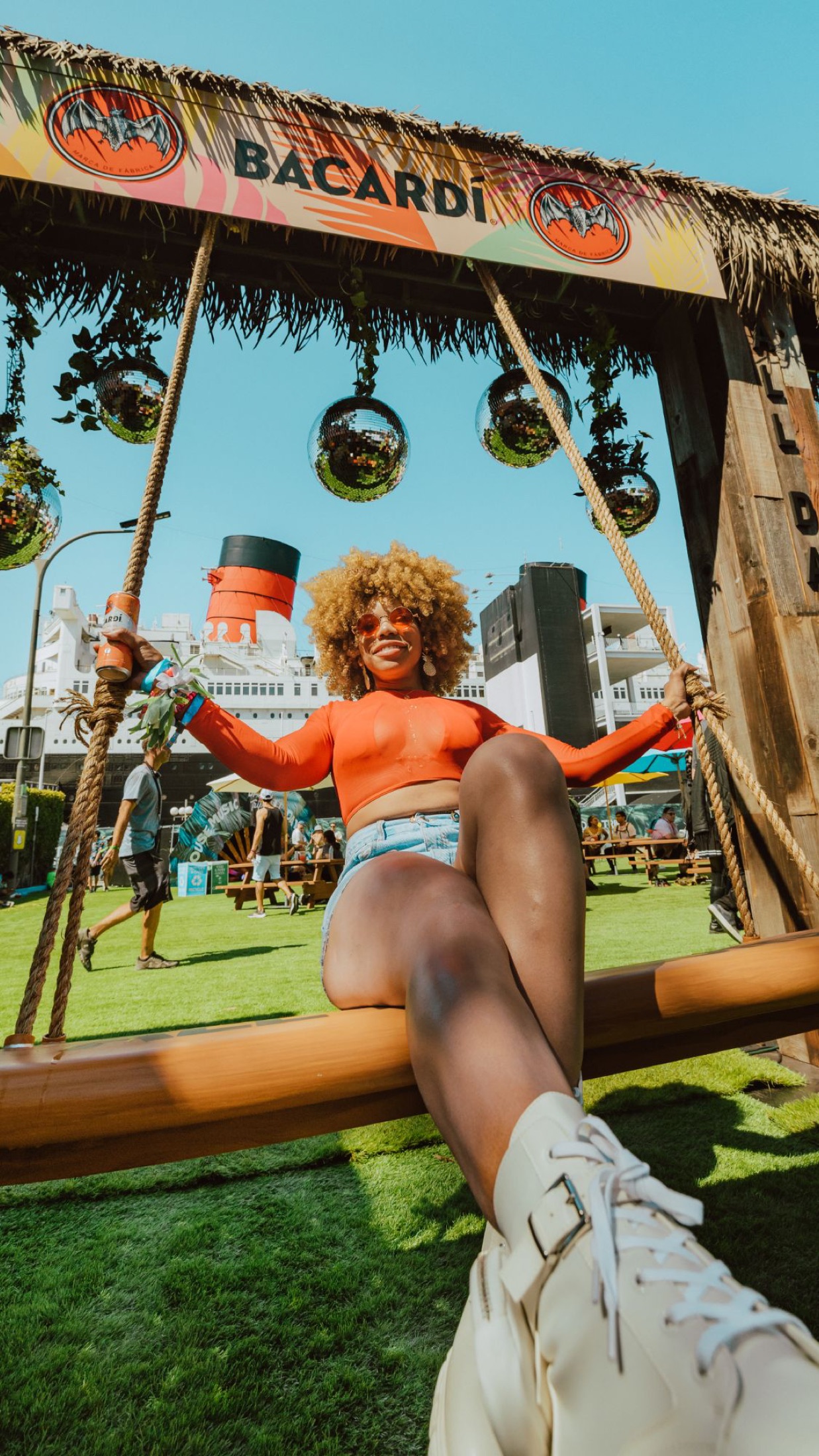 Bacardí disco-ball swing set against the Queen Mary at Day Trip