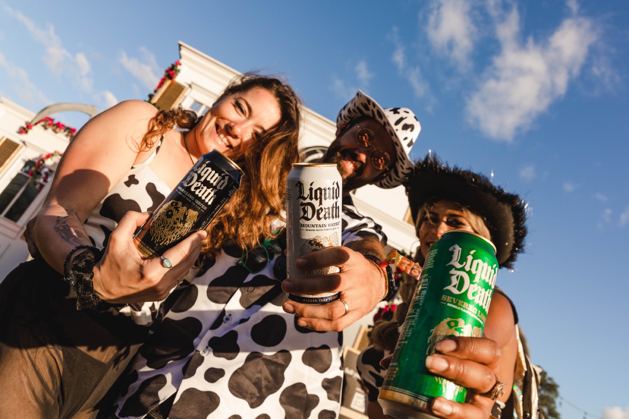 Liquid Death cow-print crew at golden hour